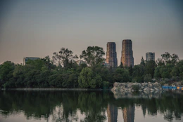 A body of water surrounded by trees and buildings