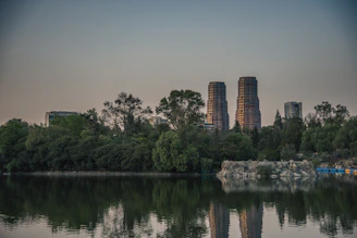 A body of water surrounded by trees and buildings