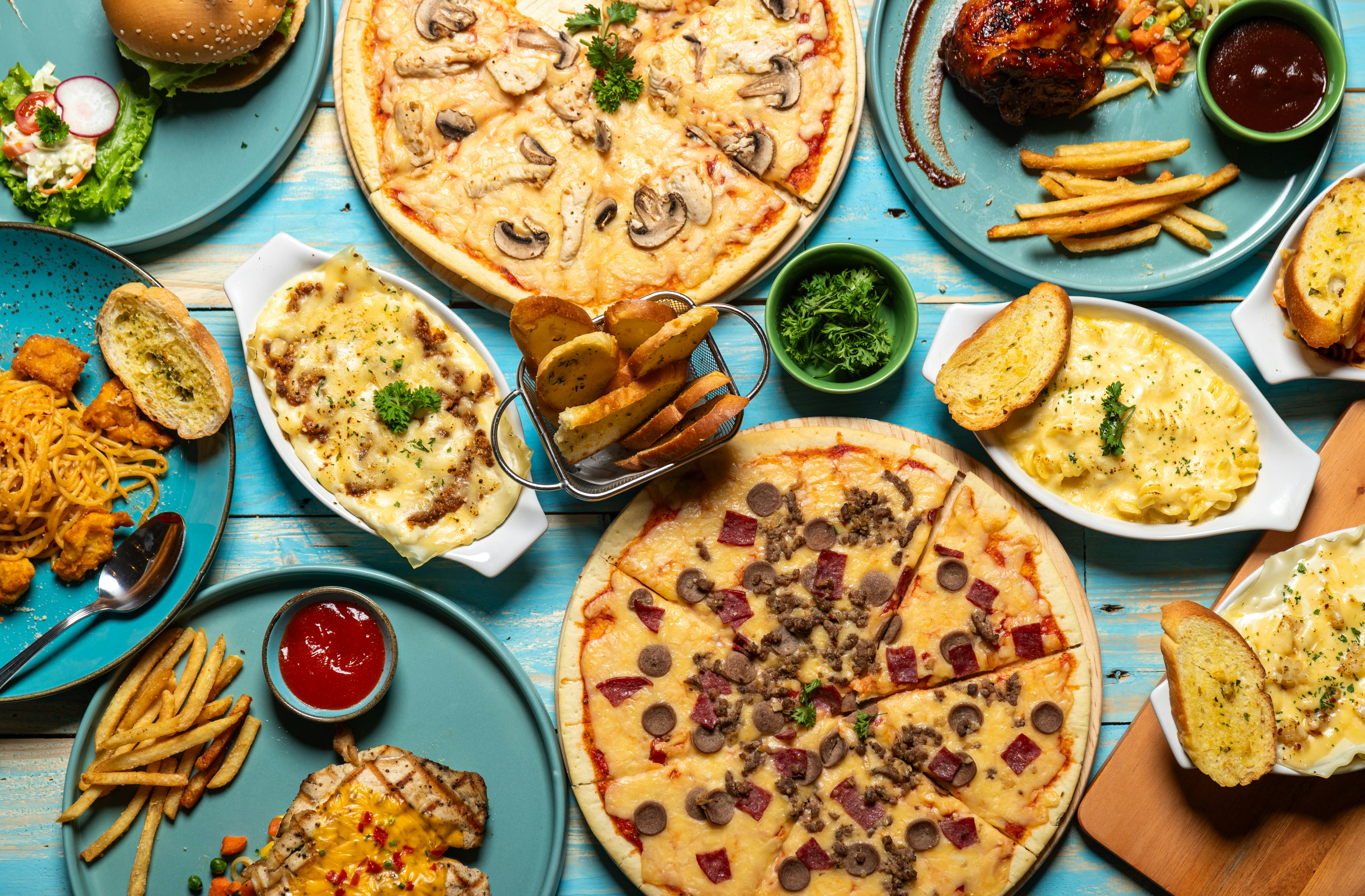 Sample cheat day meal spread with pizza, desserts, and various indulgent foods - 4-hour body