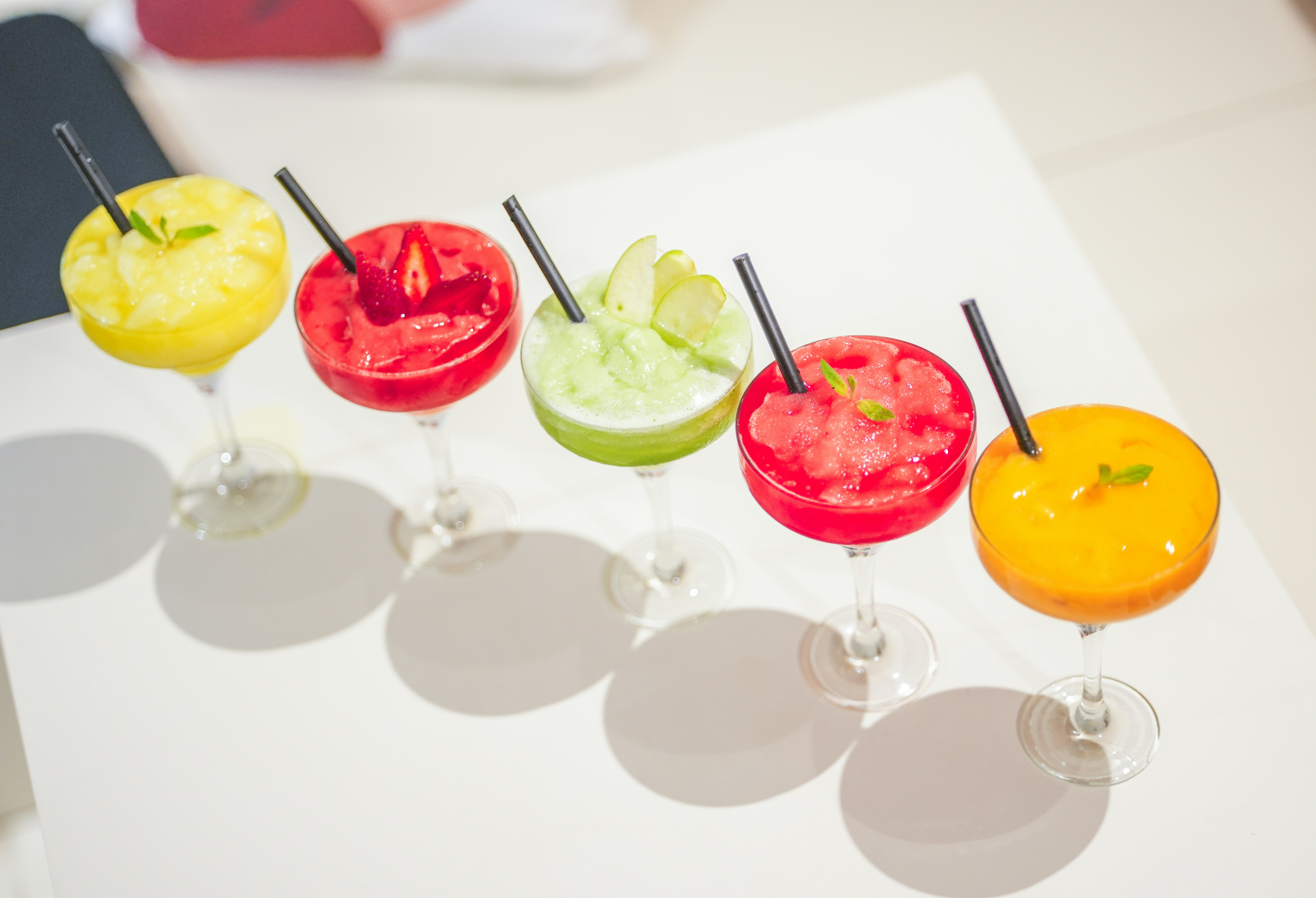 colorful mimosa flight with various fruit flavors - bottomless mimosa brunch Uptown