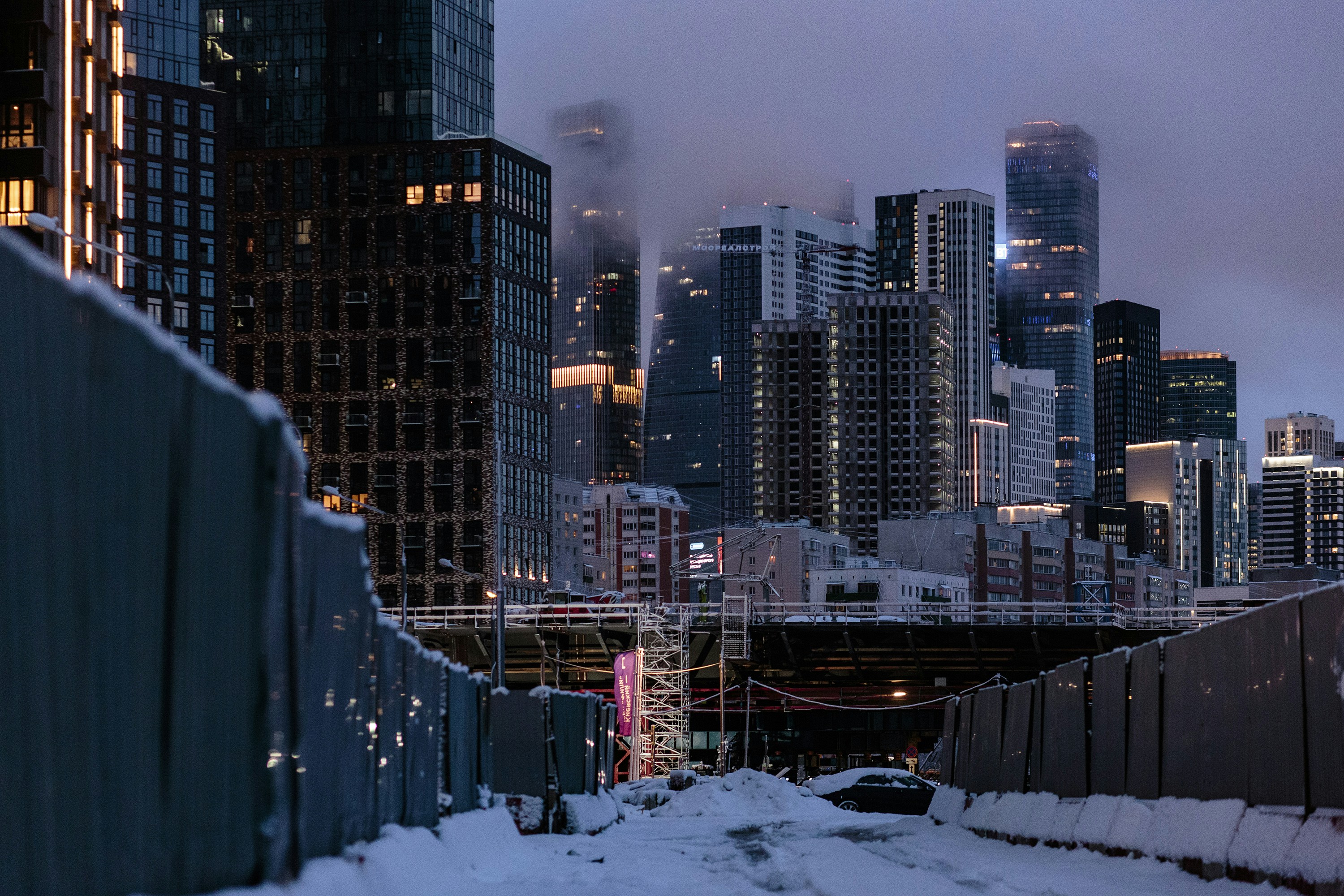 A view of a city from a bridge in the snow