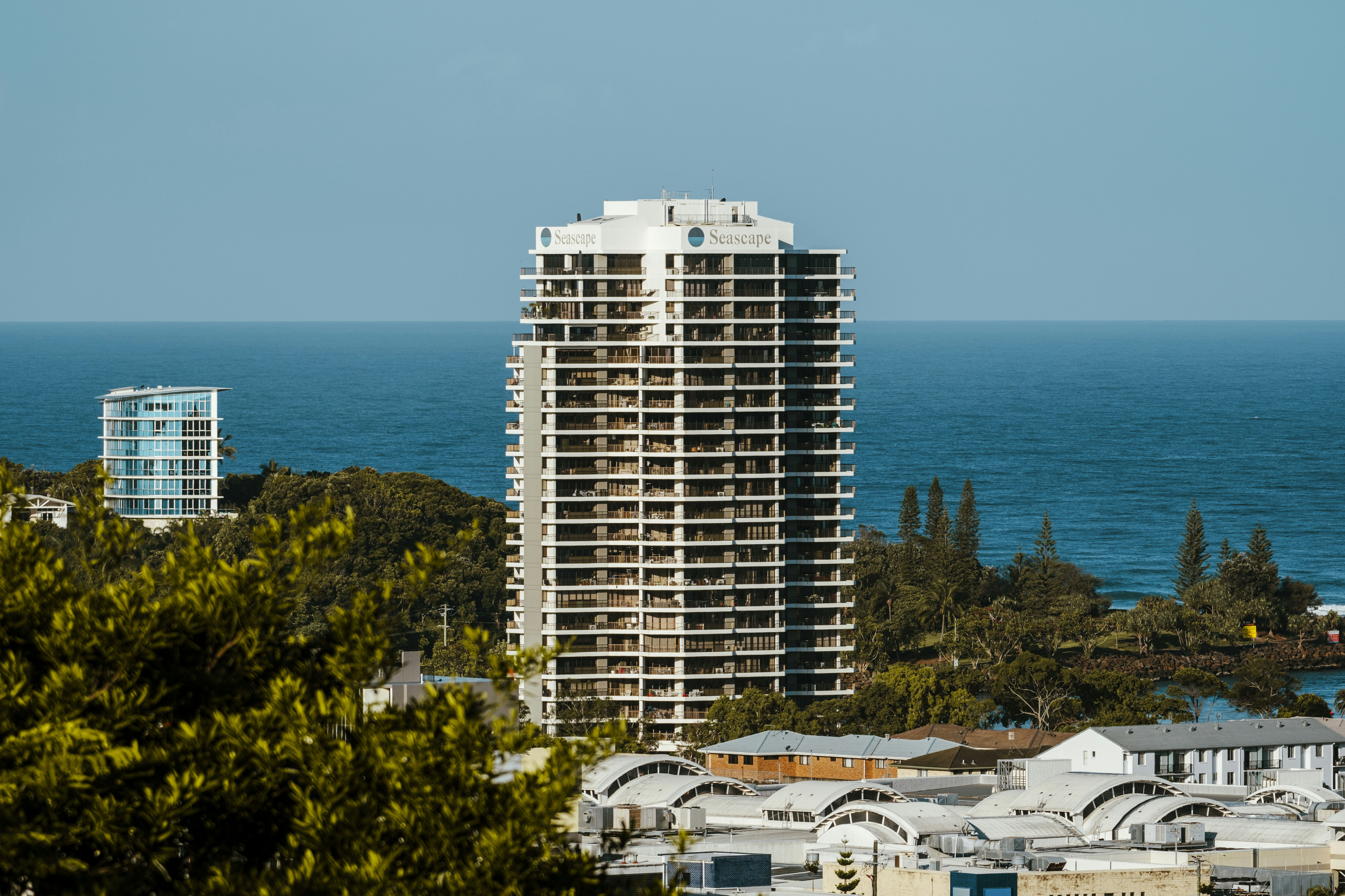 A view of a city with a large body of water in the background
