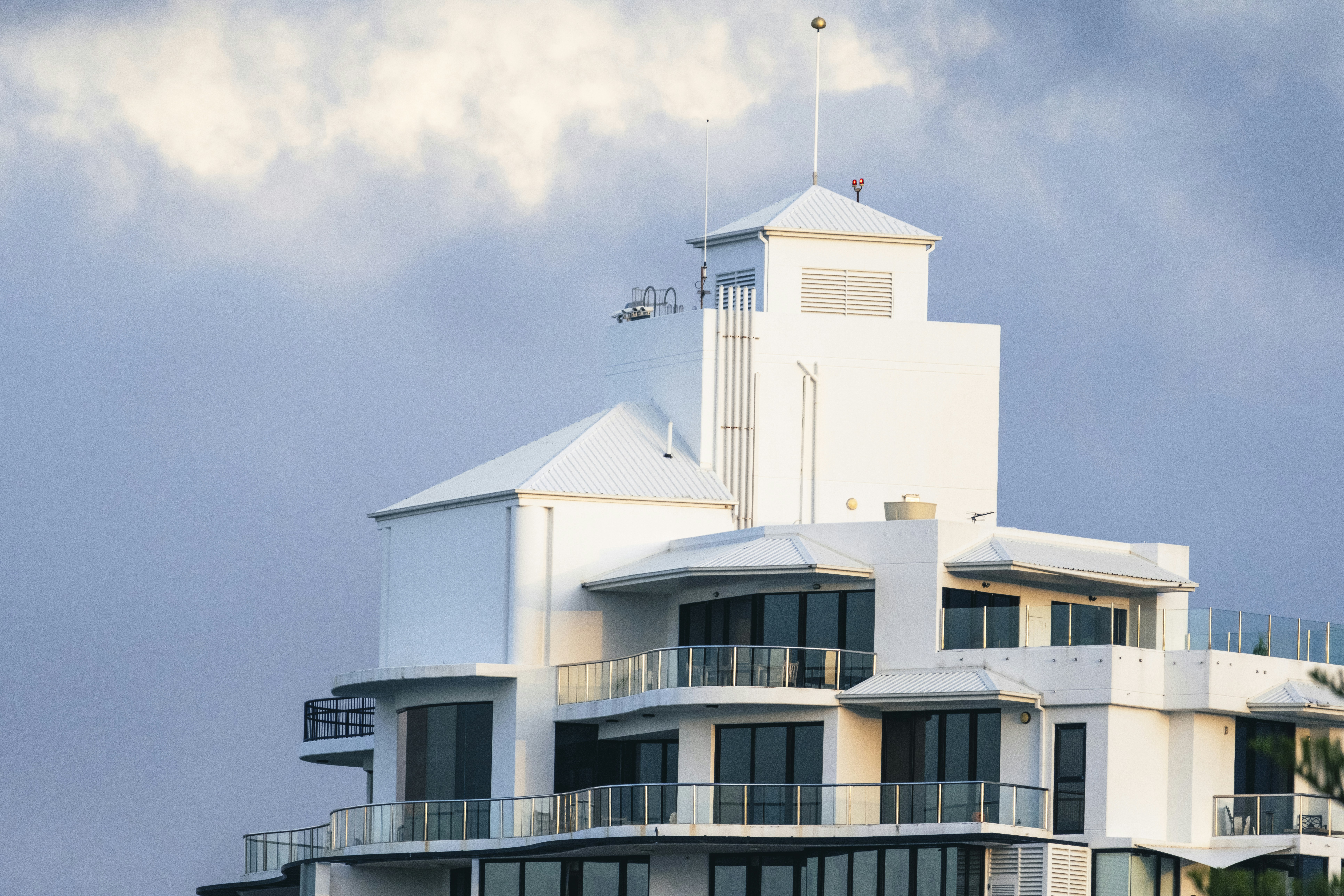 A large white building with balconies on top of it