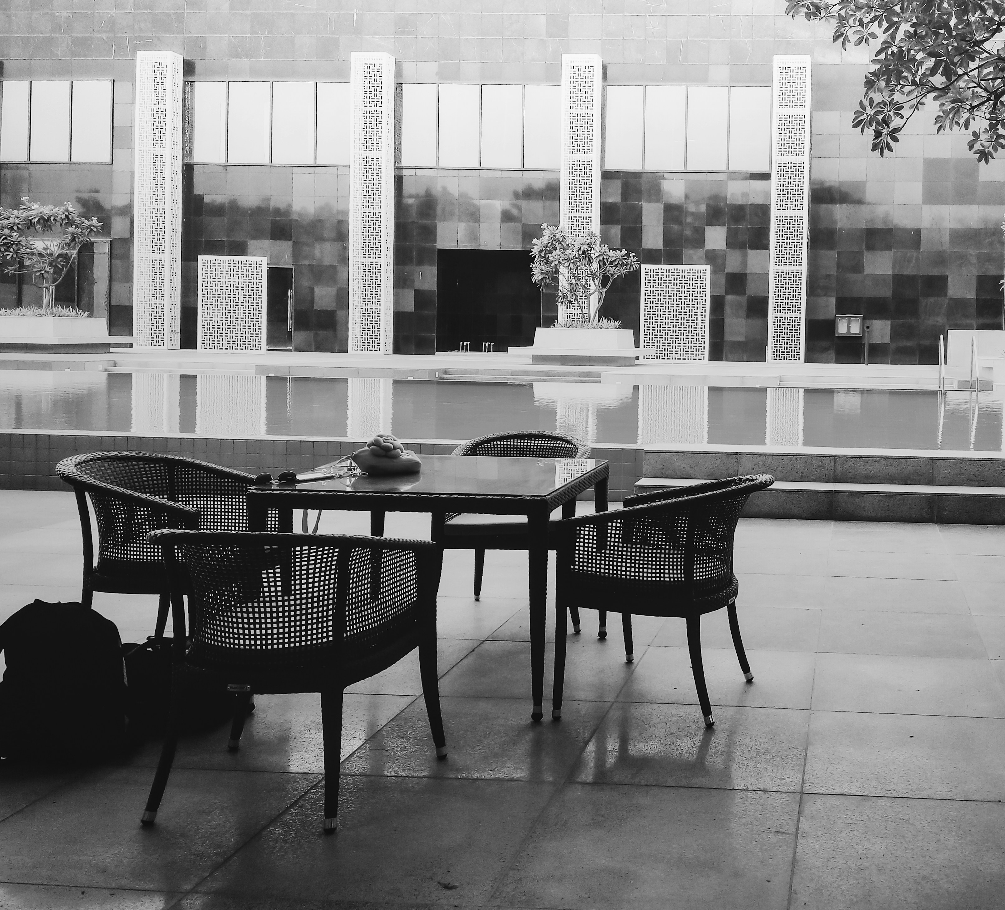 A black and white photo of a table and chairs