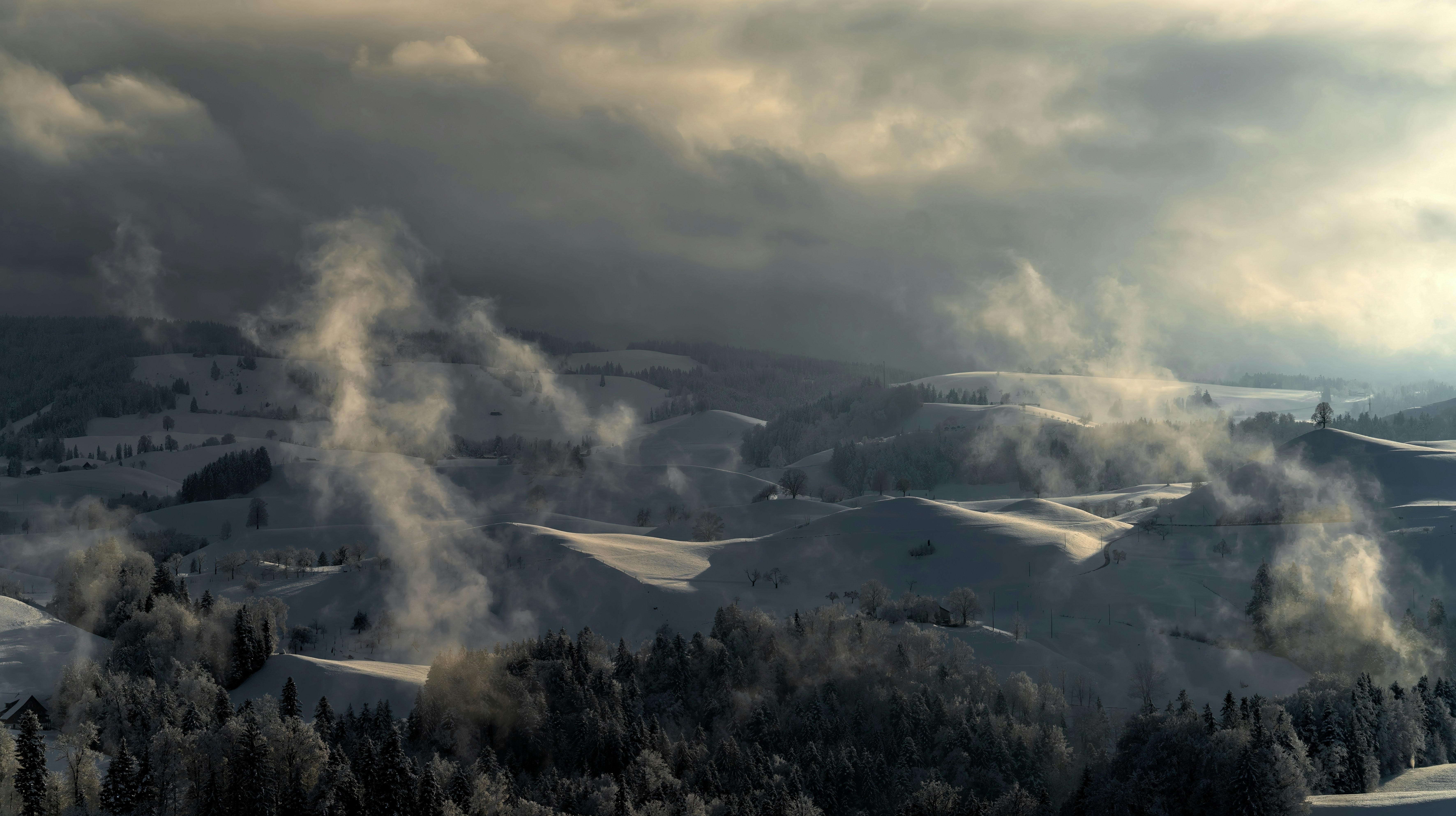 A view of a snow covered mountain with steam coming out of it