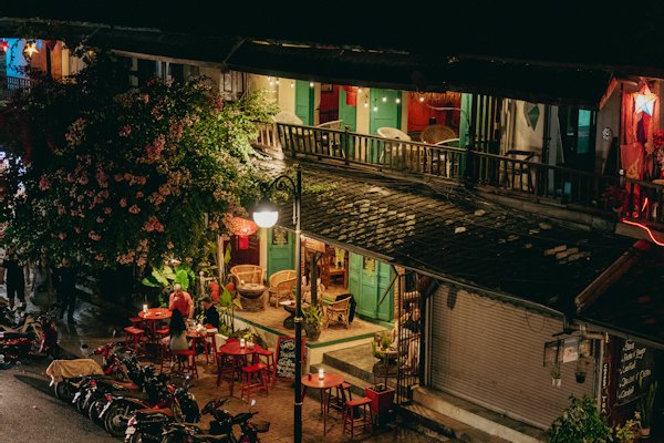 A night time view of a building with many tables and chairs — Luang Prabang, Laos