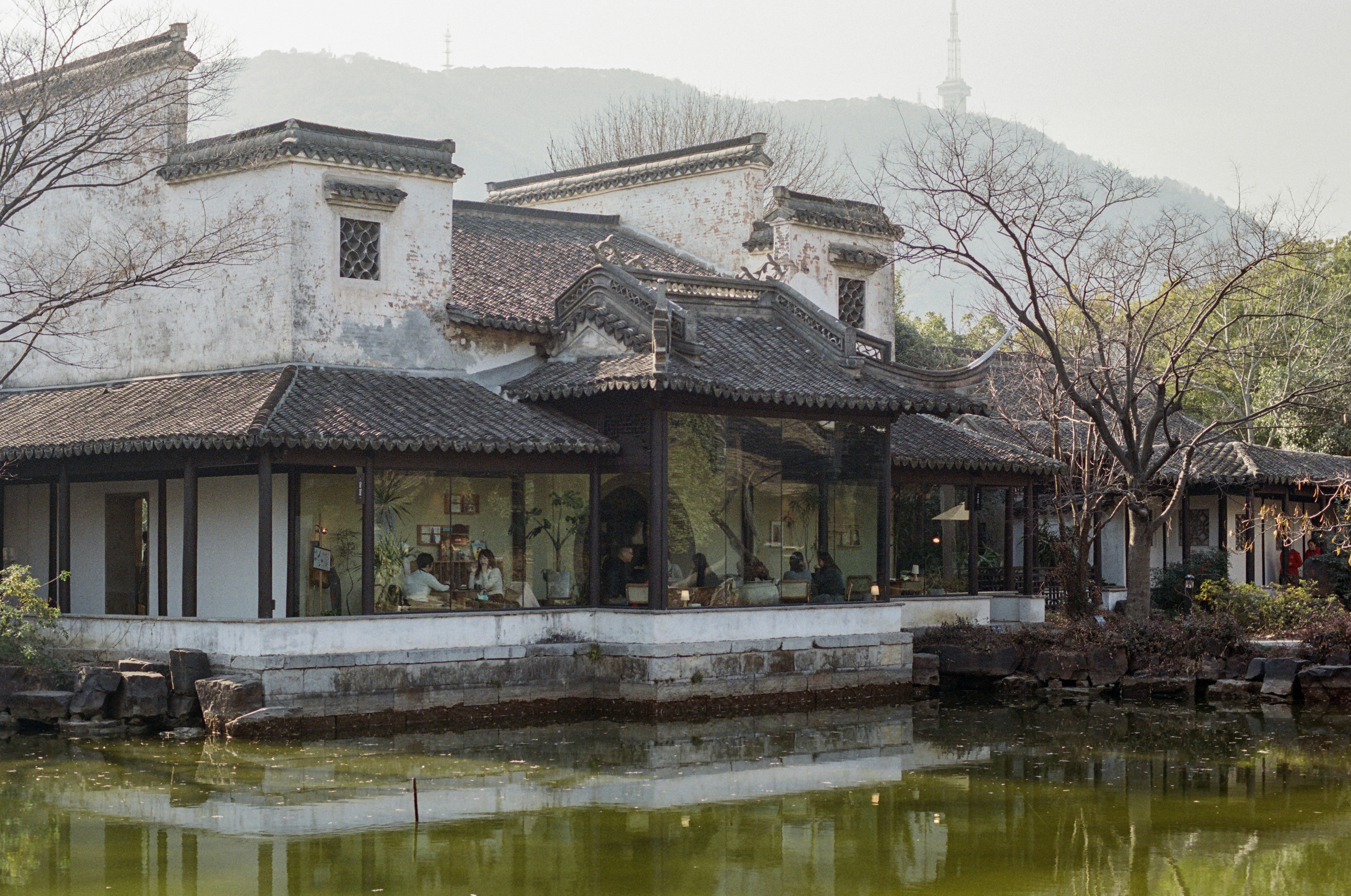 A building with a pond in front of it
