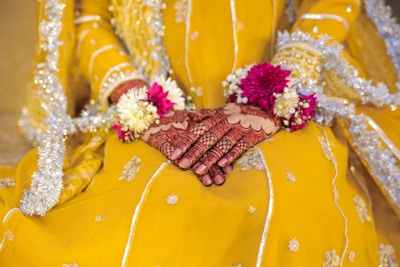 A woman in a yellow dress holding a bouquet of flowers