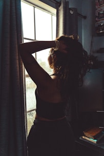 A woman standing in front of a window