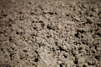 A close up of a dirt surface with small holes