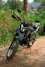 A motorcycle parked on the side of a dirt road