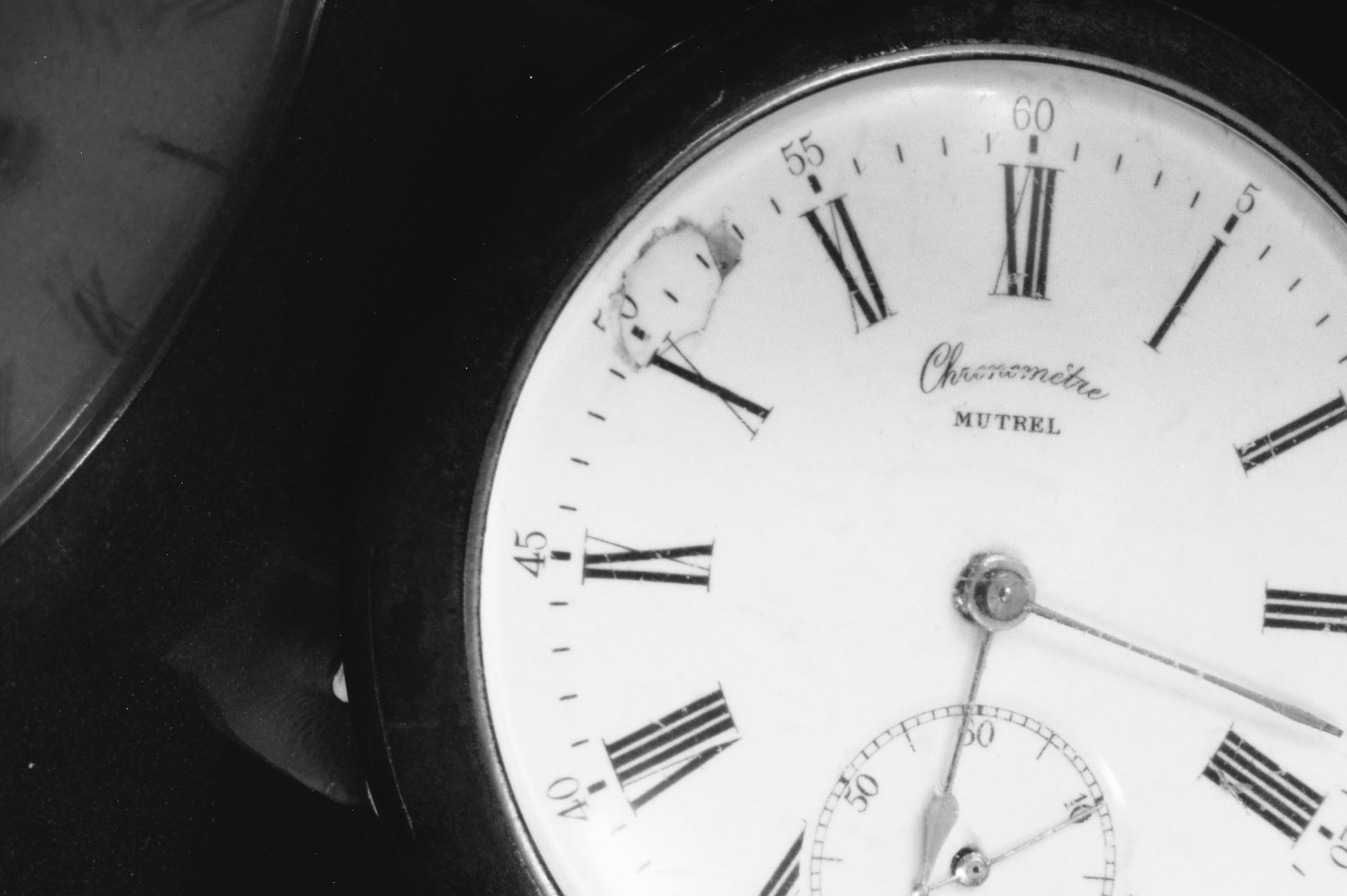 A close up of a clock with roman numerals