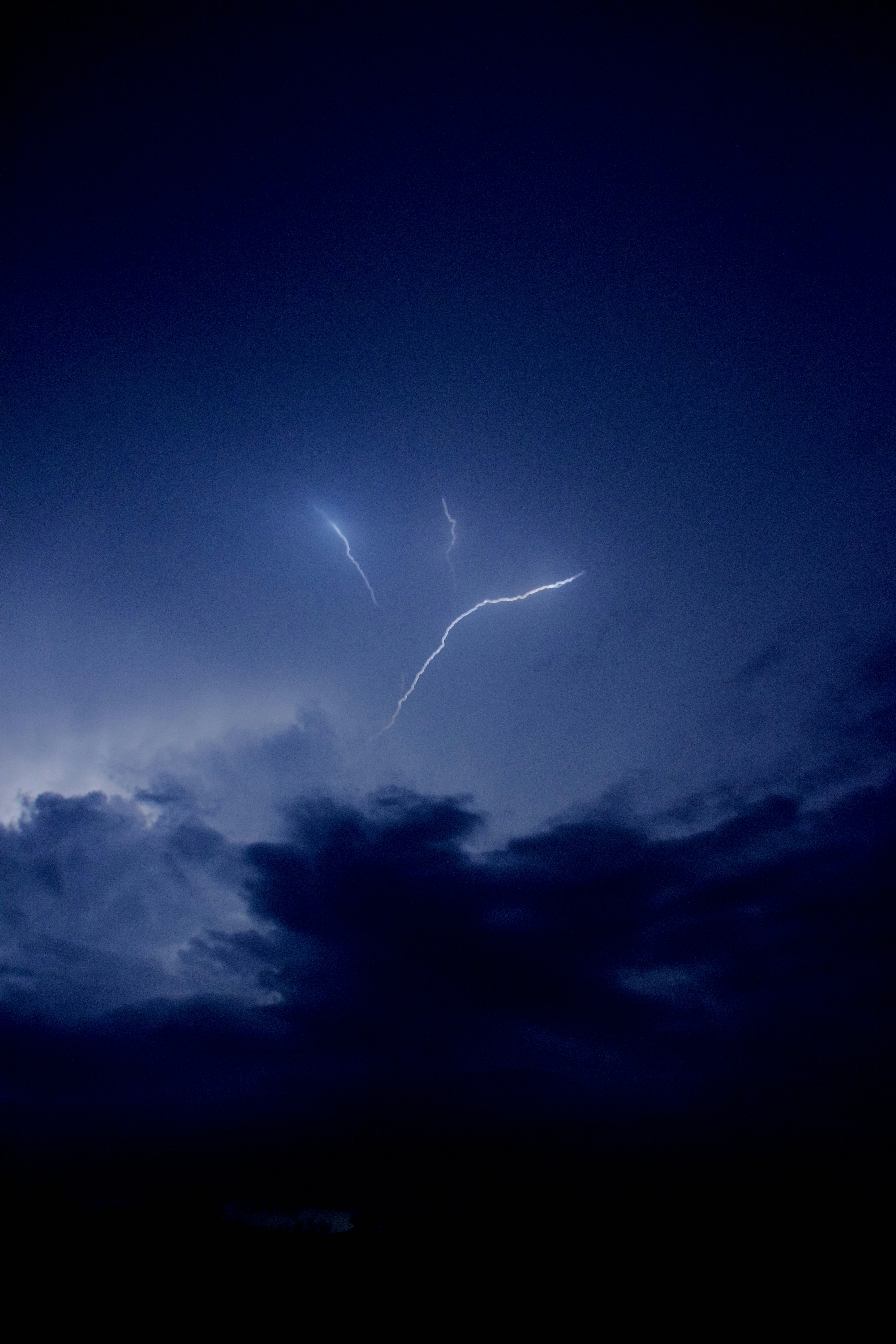A lightning bolt is seen in the night sky photo – Free Clouds Image on ...