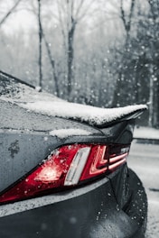 A car is covered in snow on a snowy day