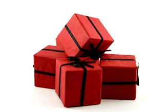 A group of red wrapped presents sitting on top of each other