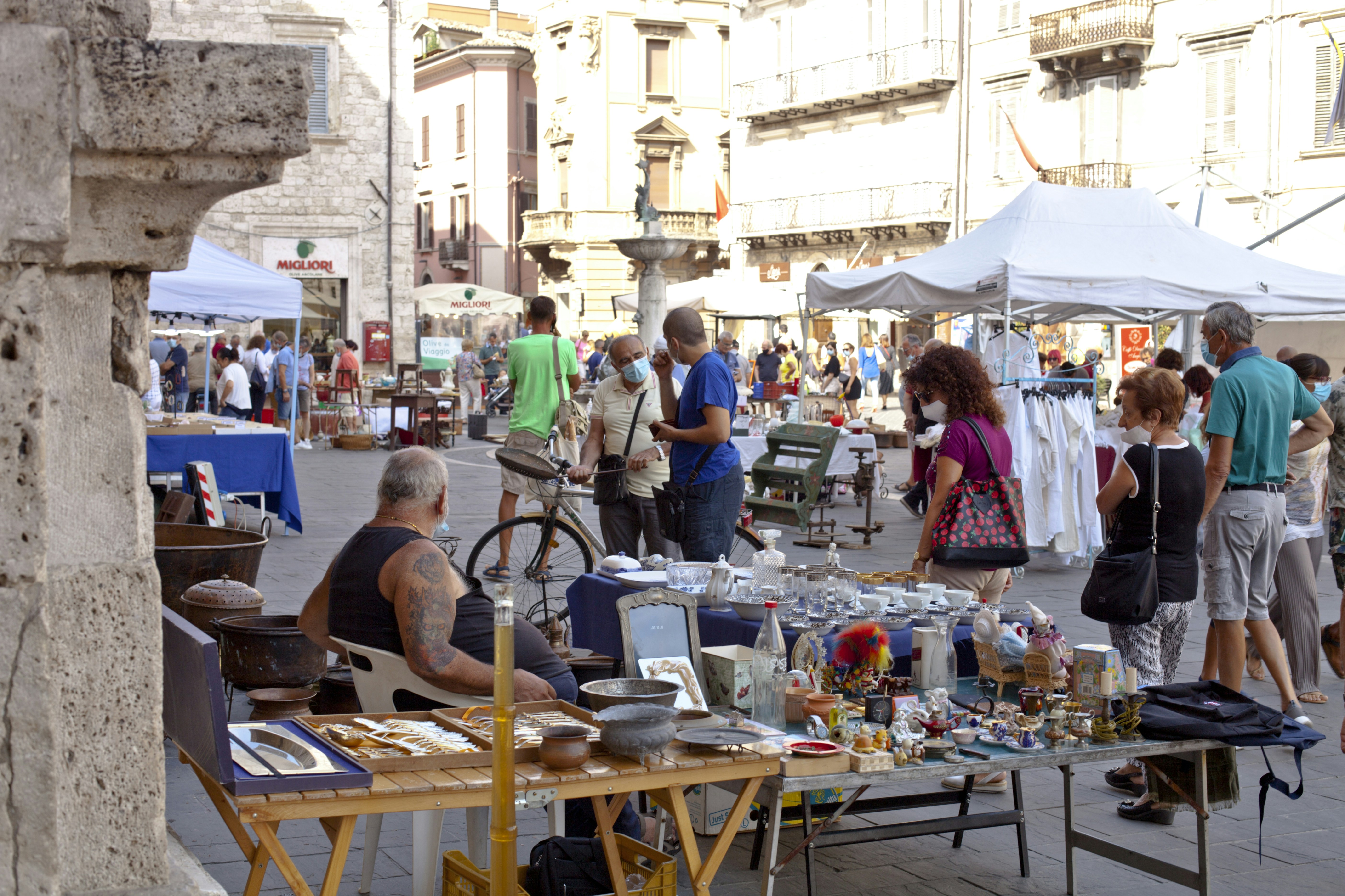 A group of people standing around a table filled with items