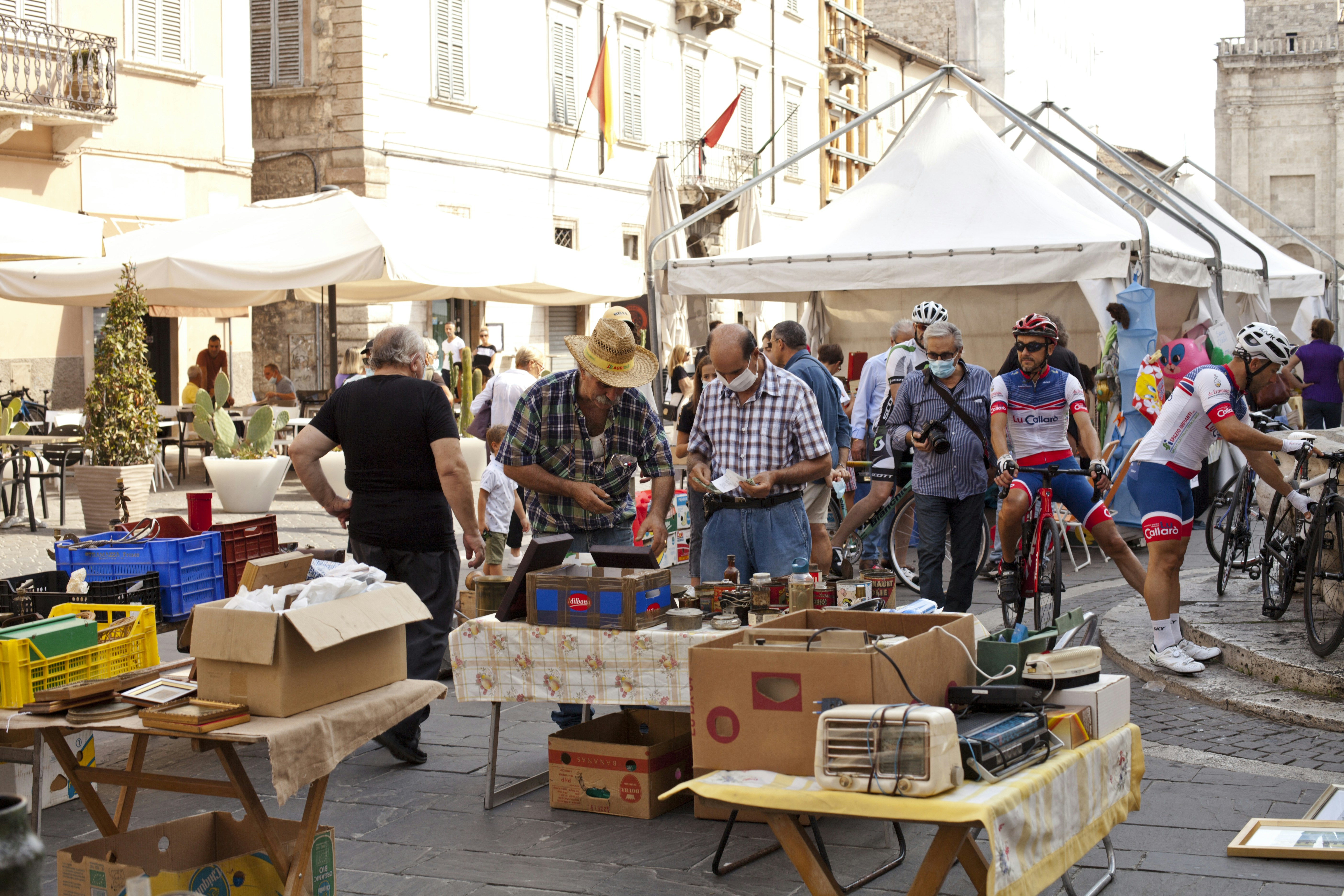 A group of people standing around a table with boxes on it