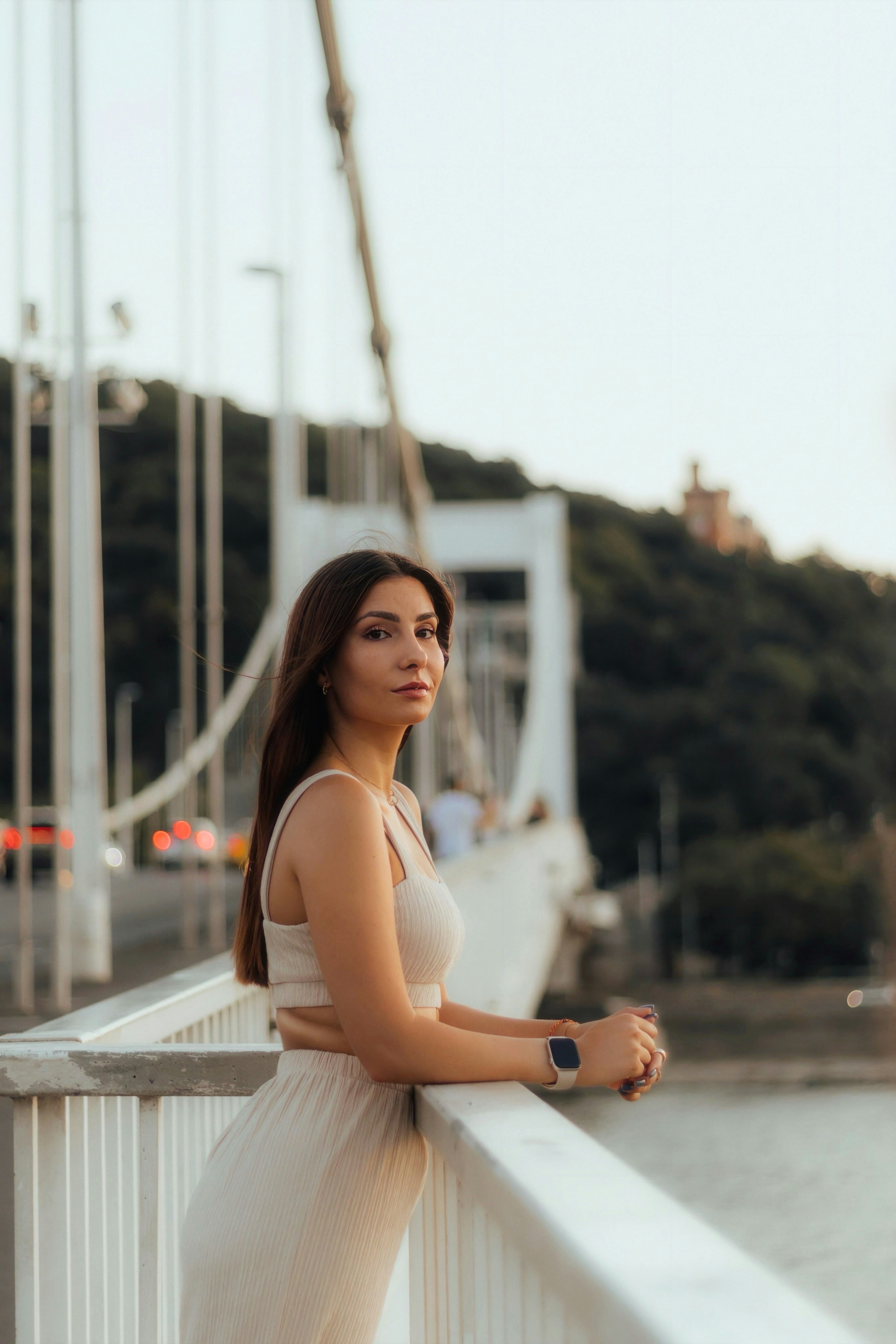 Una donna in piedi su un ponte accanto a uno specchio d'acqua