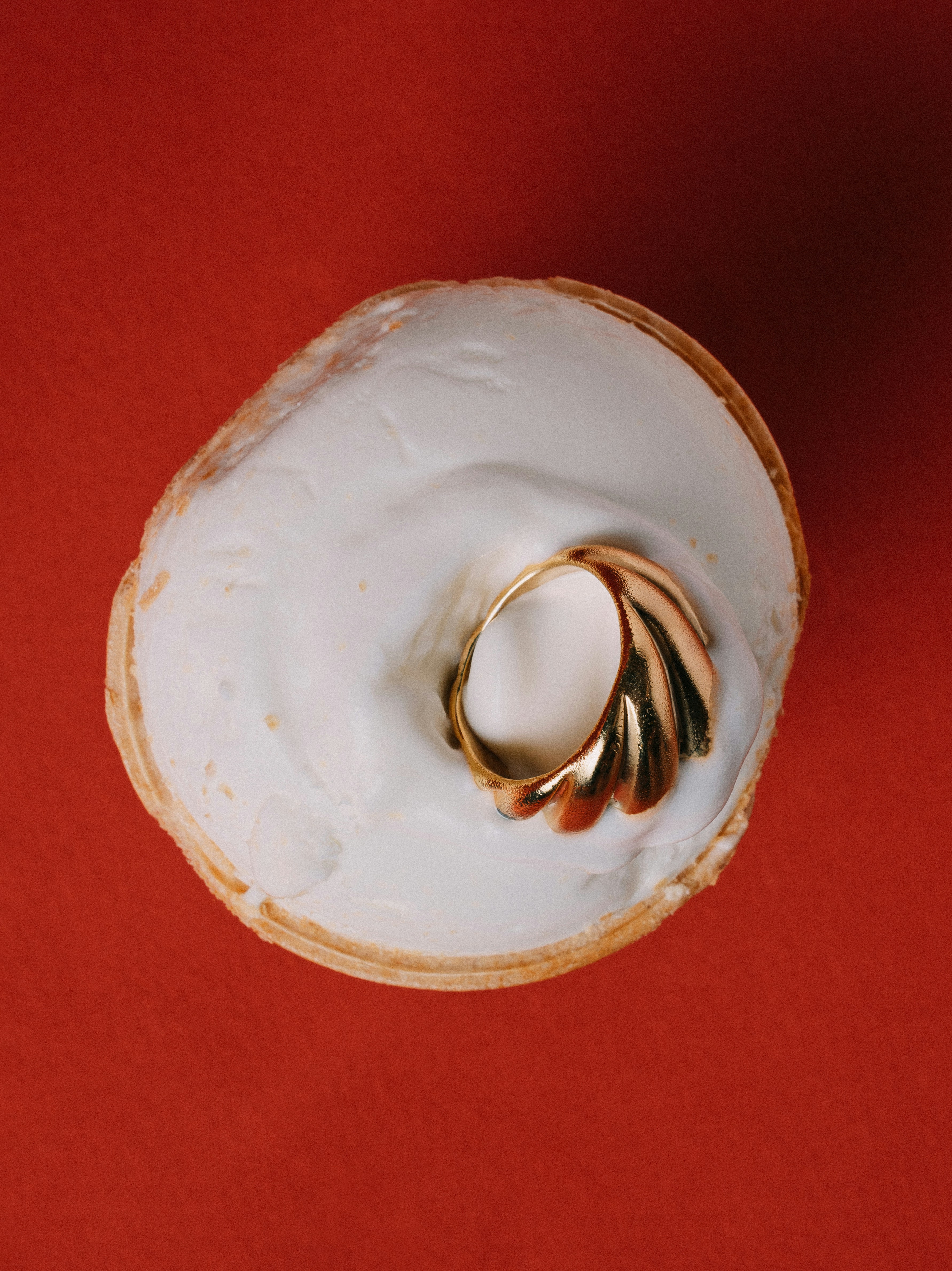 A donut with a gold ring on top of it