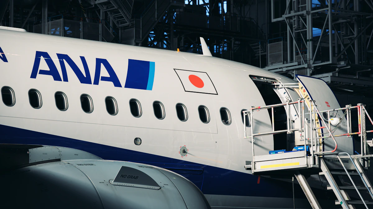 A large commercial airplane parked in a maintenance hangar