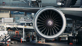 A large jet engine sitting on top of an airport tarmac