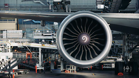 A large jet engine sitting on top of an airport tarmac