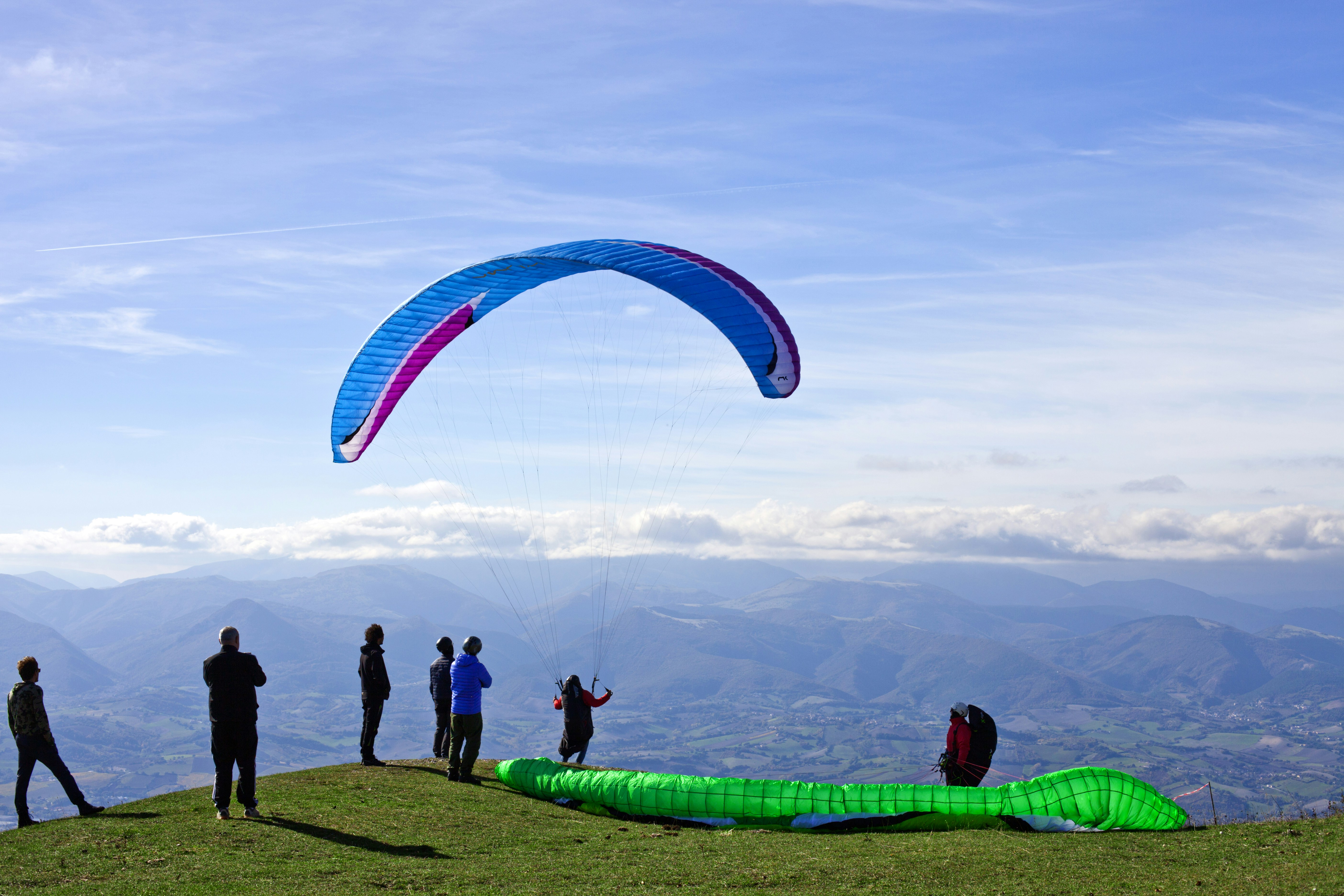 A group of people on a hillside suggests a training or instructional environment.