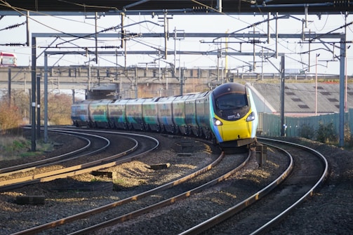 A train traveling down train tracks next to a train station
