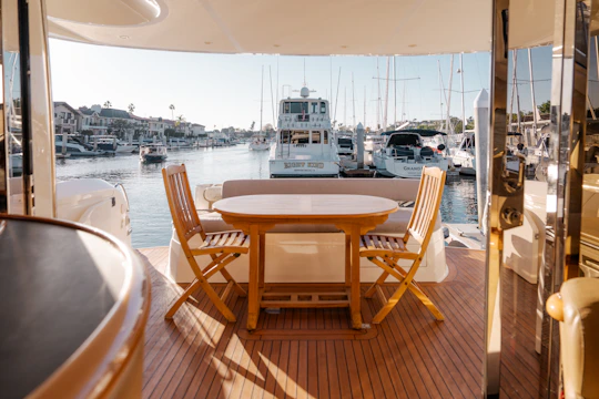 A table and chairs on a boat in the water