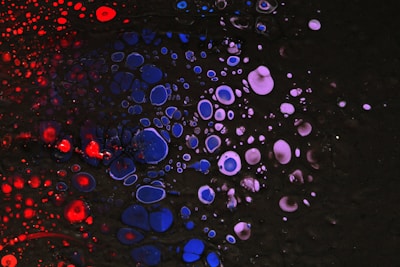 A black background with red, white and blue bubbles