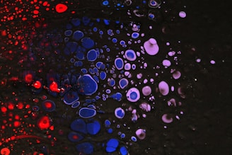A black background with red, white and blue bubbles