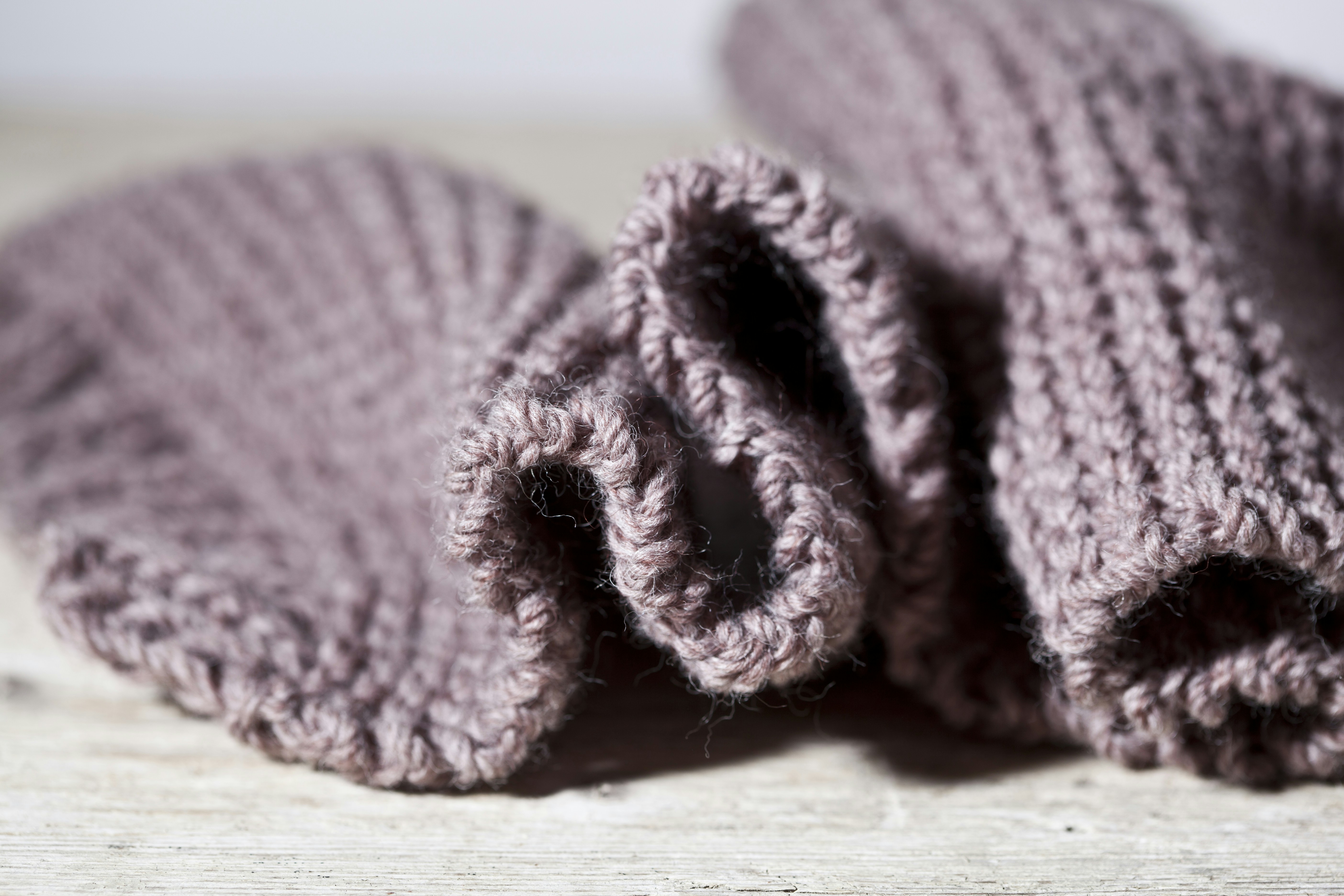 A close up of a pair of knitted mittens