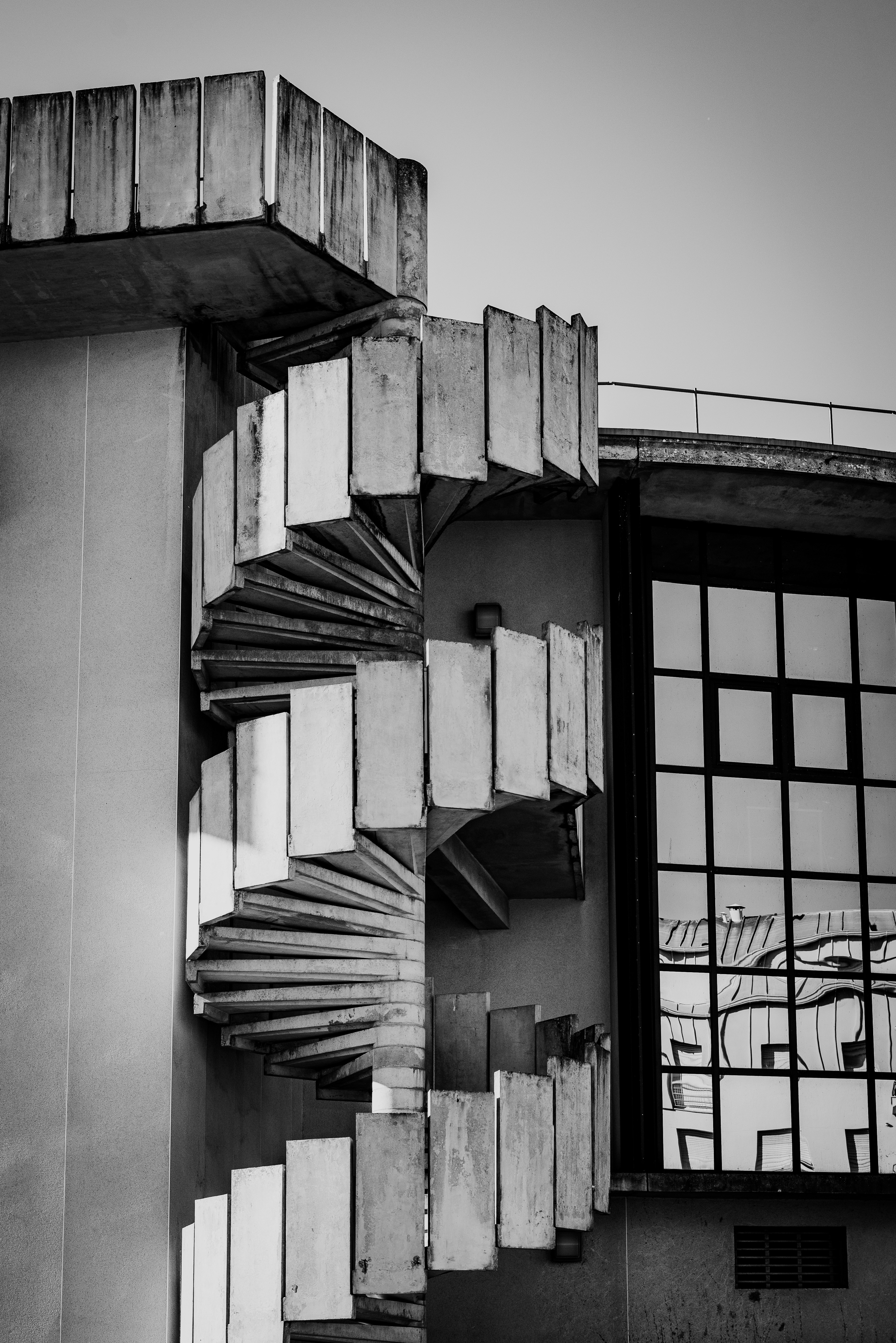 A black and white photo of a building with a clock
