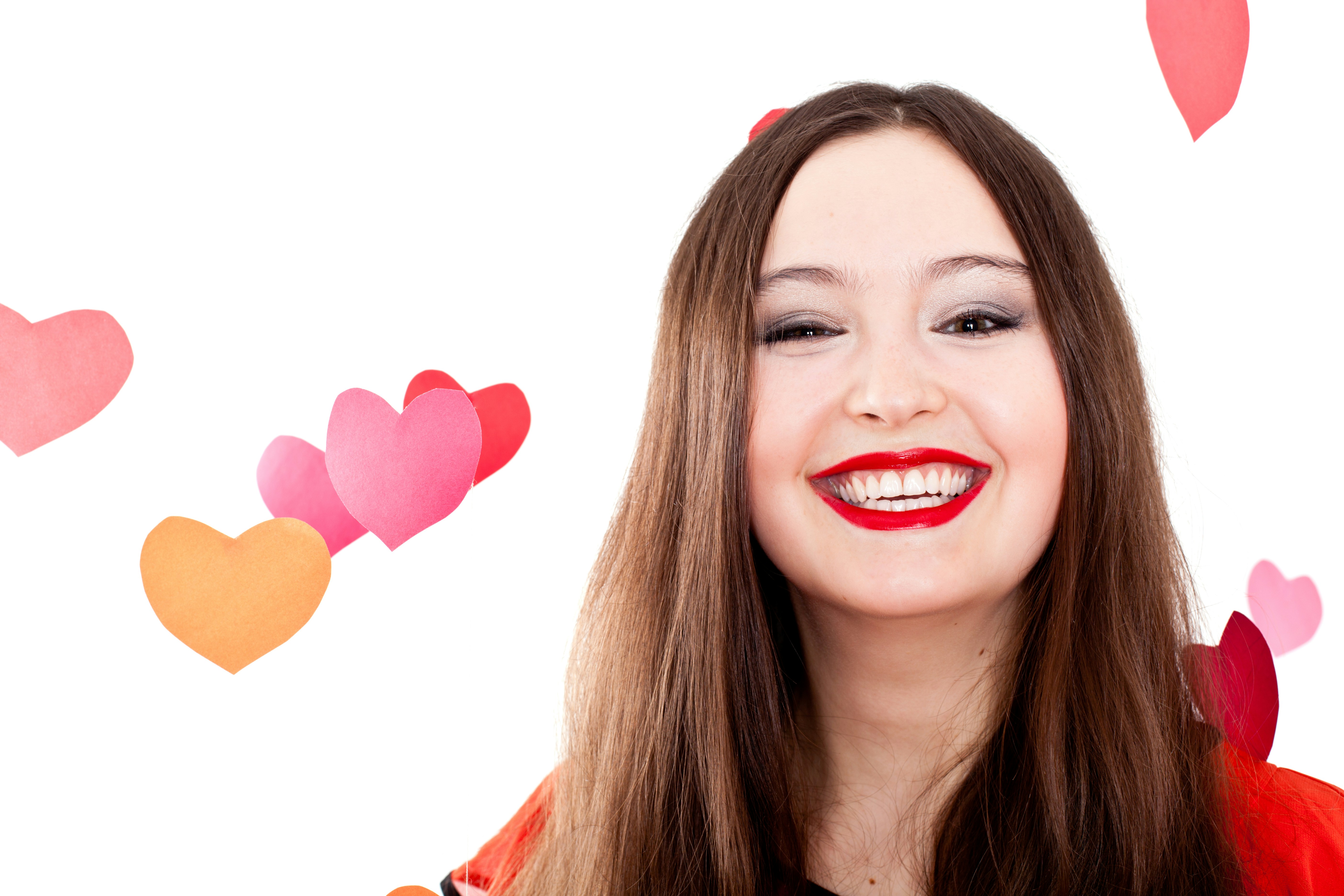 A woman with long brown hair and red lipstick
