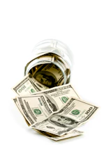 A glass jar filled with money sitting on top of a table