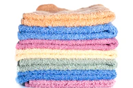 A stack of multicolored towels on a white background