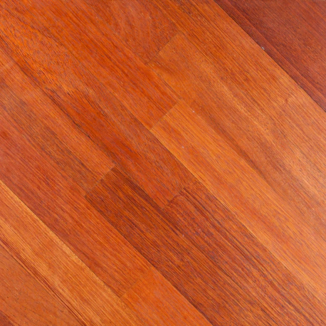 A close up of a wooden floor with a dog laying on it