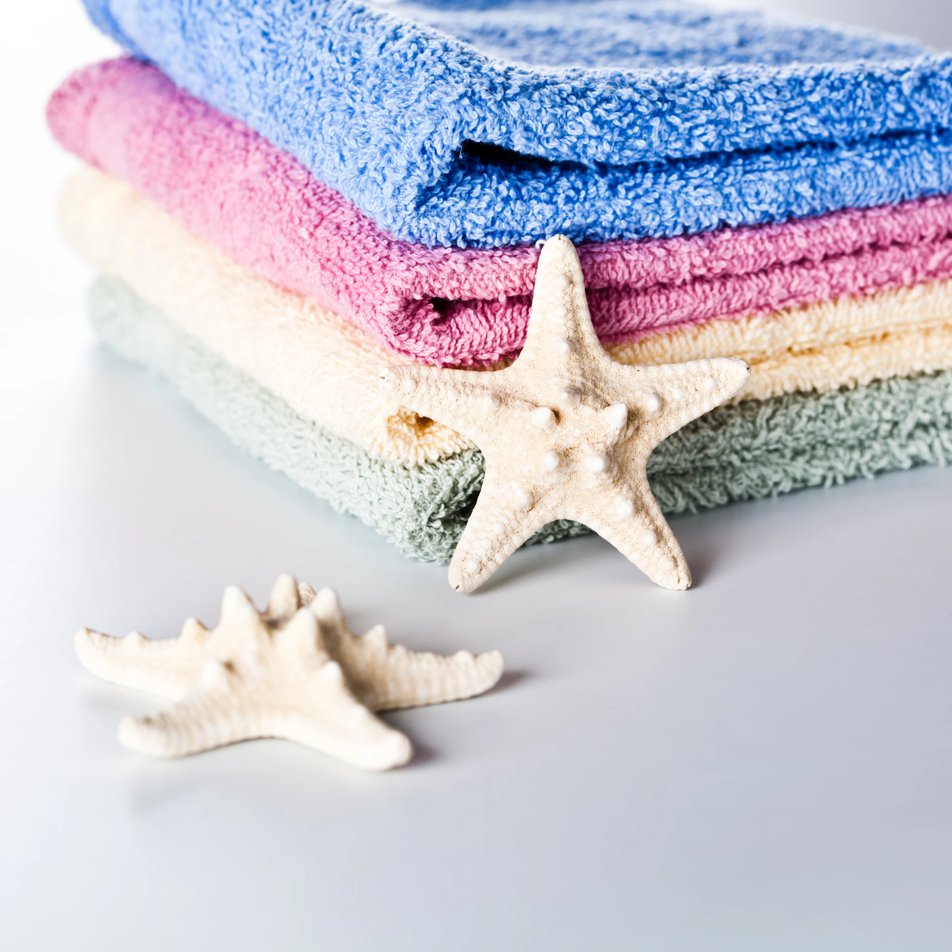 A stack of towels and a starfish on a table