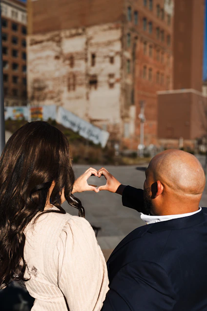 A man and a woman holding a heart shaped object