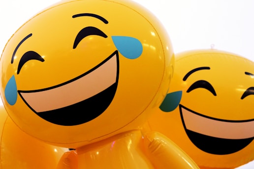 A couple of balloons that have faces on them