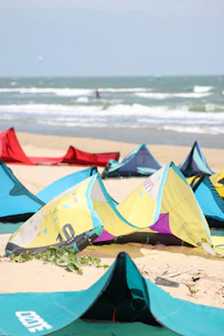 A group of tents sitting on top of a sandy beach