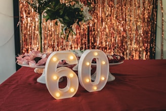 A table topped with a cake covered in white frosting