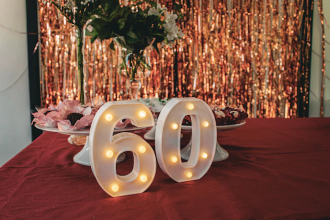 A table topped with a cake covered in white frosting