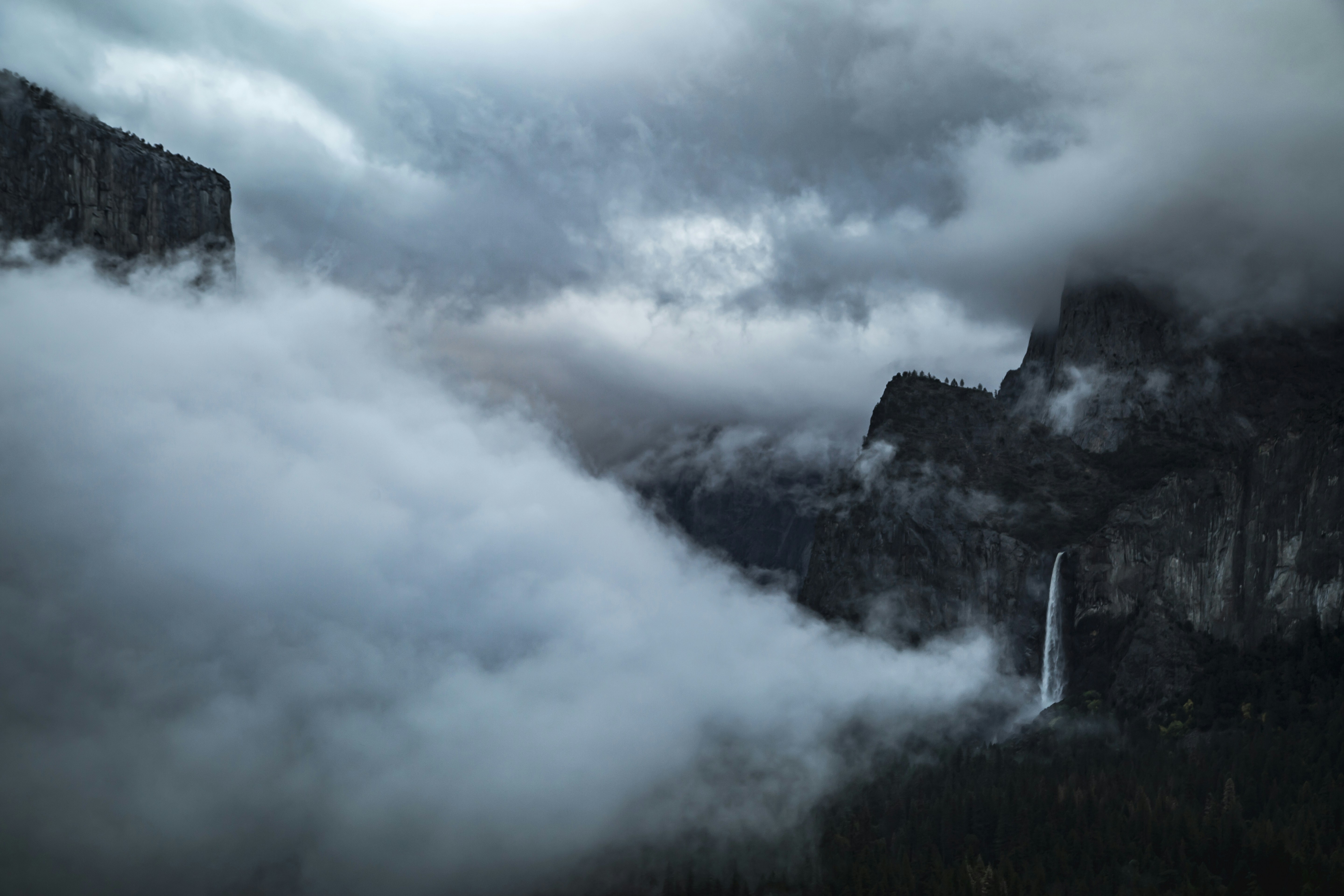 A view of a mountain with a waterfall in the middle of it