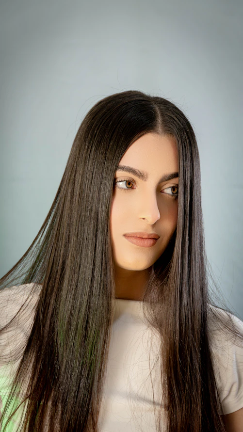 A woman with long hair is posing for a picture