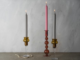 A couple of candles sitting on top of a table