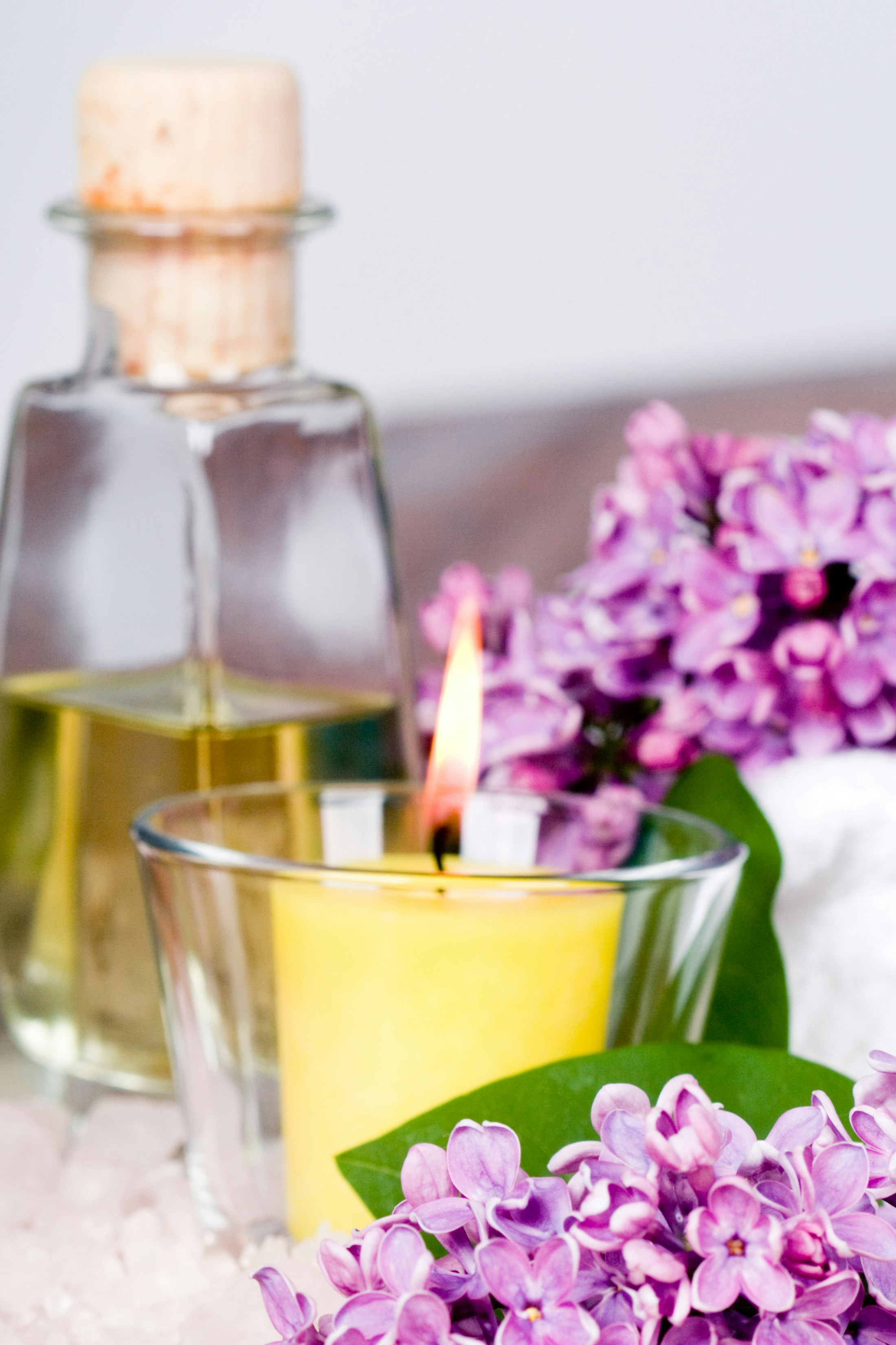 A candle and some flowers on a table