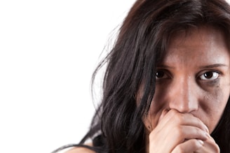 A woman covers her mouth with her hands