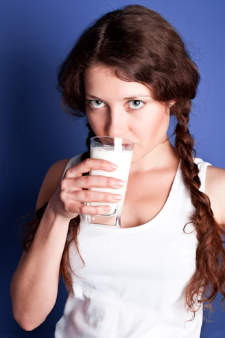 A woman drinking a glass of milk