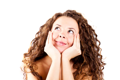 A woman with her hands on her face